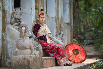 Pretty young Asian woman dressed elegantly in dress Luang Prabang Laos style for the Songkran...