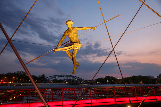 Cracow, Poland - May 2, 2022: Balancing sculptures between sky and water by Jerzy Kedziora over the Kornatka footbridge over the Vistula River in Krakow