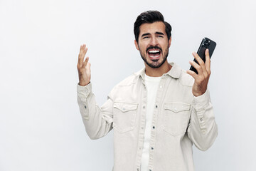 Close-up portrait man talking on the phone anger dissatisfaction and annoyance on a white isolated...