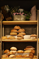 A lot of different bread on the shelves in the baking store