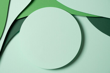 Blank light green round geometric shape podium platform on paper cut abstract geometric shape green background. Top view mock up for product display