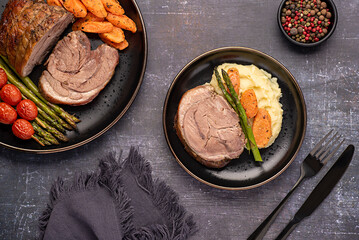 Food photography of roasted lamb, carrot, asparagus, tomato, seasoning, pepper