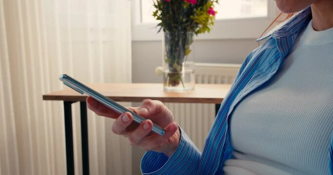 Closeup business woman typing message on mobile smart phone at home office, chatting on smartphone