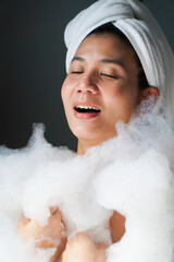 woman in bathtub having sexy bubbles