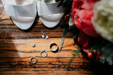 Rings and rose on wooden table