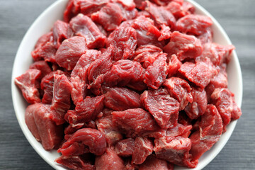 Fresh, raw beef cut into pieces, prepared for goulash - 586472233