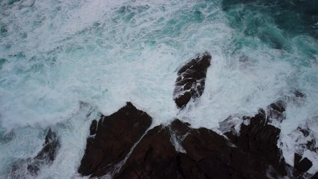 Raging Water With Foamy Waves On The Rocky Shore Of Caion Beach In Coruna, Spain. Aerial Topdown