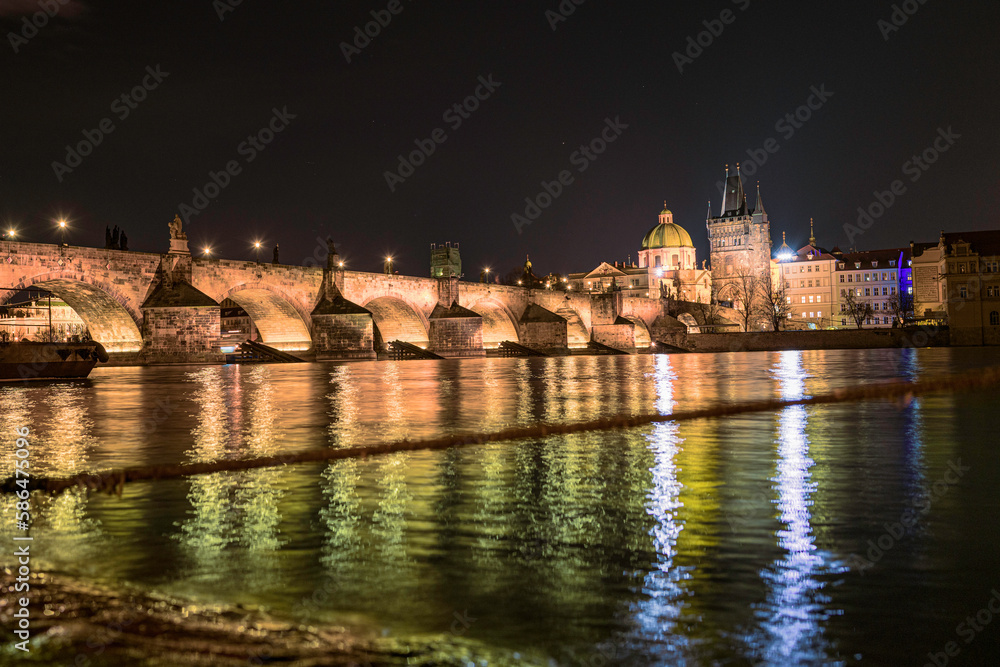 Wall mural prague nightscape with the city skyline, landmark buildings, old town towers, and charles bridge ove