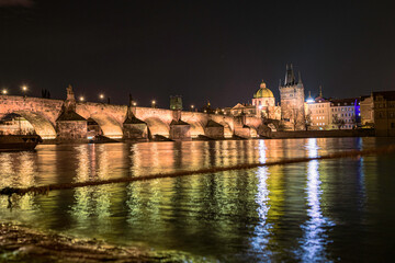 Fototapeta na wymiar Prague nightscape with the city skyline, landmark buildings, old town towers, and Charles Bridge over the Vltava River Czech Republic