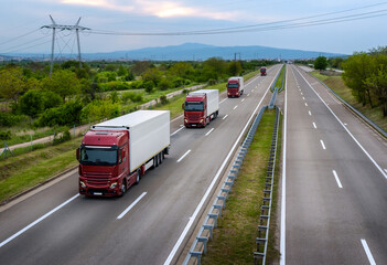 Fototapeta na wymiar Large Red Lorry Trucks with containers on highway, cargo transportation concept in springtime - freight service 