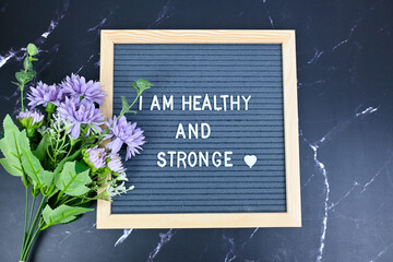 Grey letter board with phrase Self care, I am healthy and strong. Self love, Mindfulness lifestyle, mental health. Aspiration, affirmative and supportive sentence
