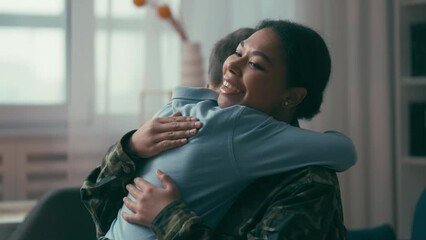 Female soldier hugging little son, military woman returning home after war