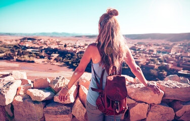 Woman looking at panoramic view of moroccan village in oasis landscape
