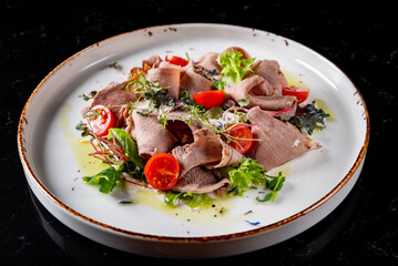 Beef tongue salad with fresh vegetables in plate
