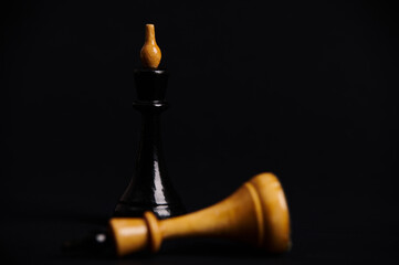 Obraz na płótnie Canvas Focus on black king chess piece fighting white king falling down on chessboard, isolated background. Development Analysis Strategy Plan, Leader and Teamwork Concept for Success. Business Solutions
