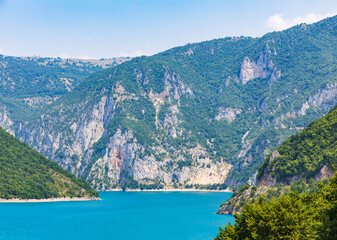 Fototapeta premium Landscape view of big lake between mountains at summer day