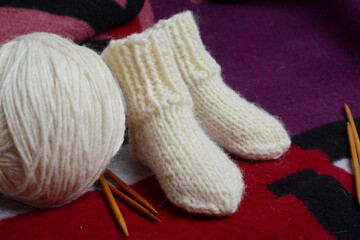 Fototapeta na wymiar Warm and rough baby socks, made of organic sheep wool yarn