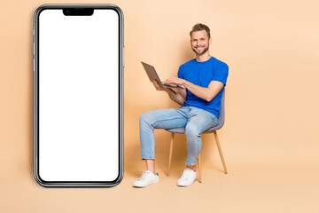 Full body profile side photo of young guy sit armchair use laptop agent isolated over beige color background