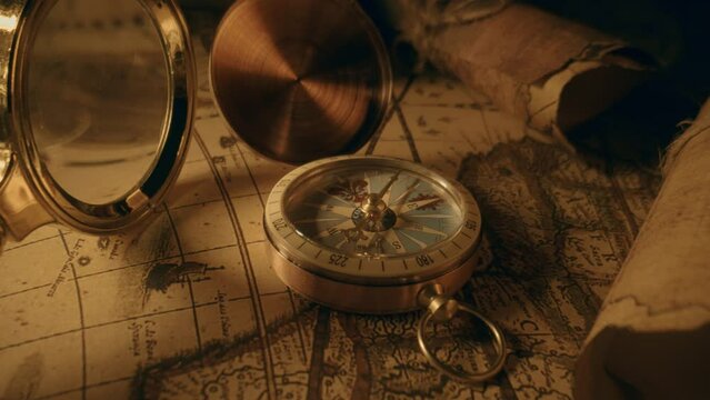 Compass and magnifier on a old vintage world map with countries and continents. Retro style. Concept of geography or global history and cartography. Wars of conquest and navigation. 4K ProRes