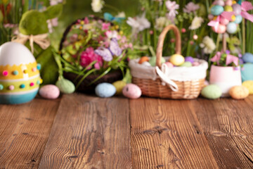 Obraz na płótnie Canvas Easter theme. Easter decorations. Easter eggs in basket and easter bunny. Bouquet of spring flowers. Rustic wooden brown table.