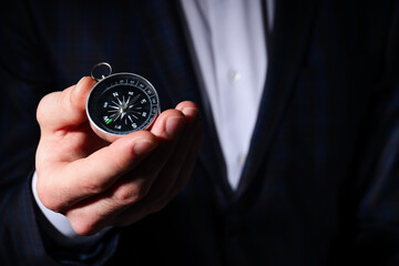 Business navigate concept with compass in businessman hand