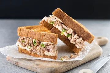 Zelfklevend Fotobehang Tuna sandwich with mayo and vegetables on gray stone background. © chandlervid85