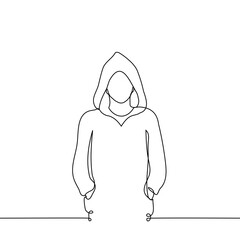 man with hoodie stands looking at the viewer, on his head is a hood with hands in pockets