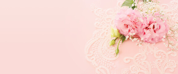Close up image of delicate pink flowers over pastel background