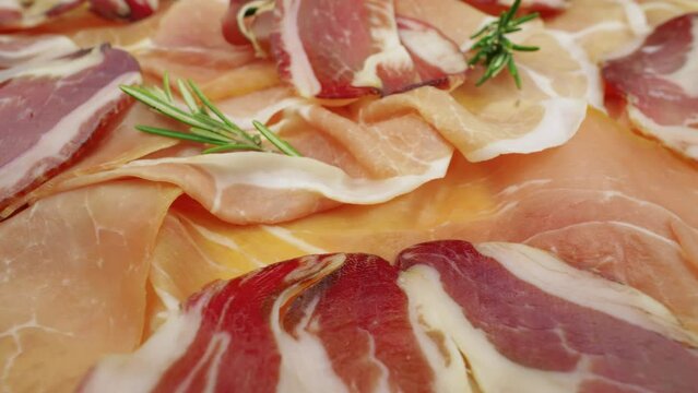 Seasoned and dry-aged ham. Slices of Spanish Jamon. Prosciutto crudo, Parma ham