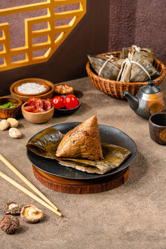 Zongzi is a traditional Chinese food made of glutinous rice stuffed with different fillings and wrapped in bamboo reed, or other large flat leaves. They are cooked by steaming or boiling.