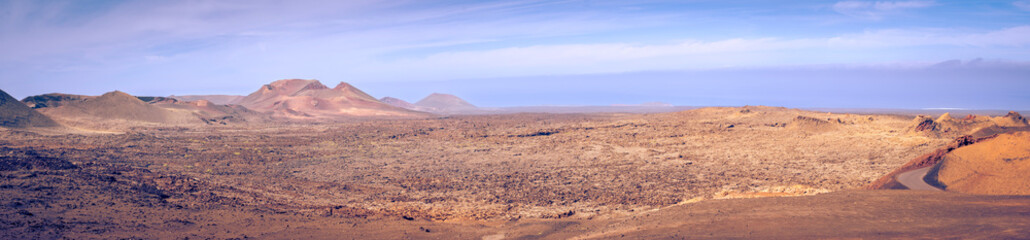 Wide panorama view on the desolate volcanic landscape of Timanfaya National Park on Lanzarote