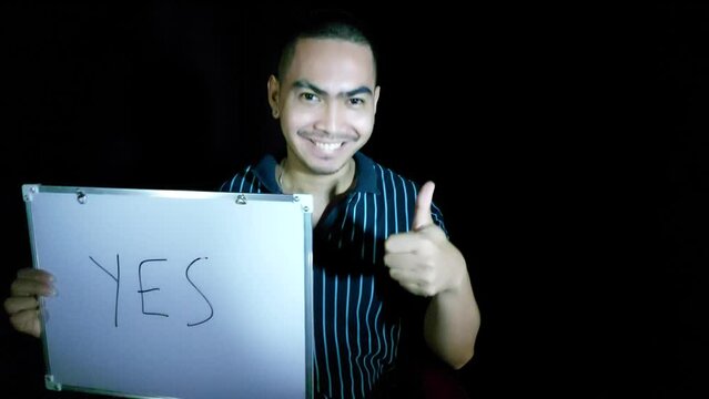 handsome young filipino man with sign