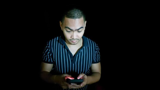 handsome young filipino man with phone