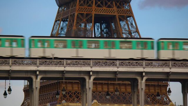 The Paris Metro is one of the popular attractions in Paris. Iron bridge over the river in Paris near the metal tower on which the Paris metro passes. Metro train over Bir-Hakeim bridge