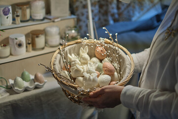 Easter Delights: Woman Holding a Basket of Bunny and Egg-shaped Candles