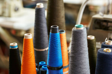 A few almost used bobbins with knitting threads