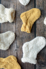 Fototapeta na wymiar Various styles handmade baby socks, on dark wooden background