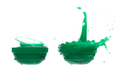 Green paint liquid fly in mid air, spill out glass bowl, apple vegetable juice falling scatter, explosion float in shape form droplet line. White background isolated freeze motion high speed shutter