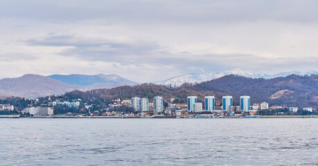 Fototapeta premium View of city of Adler and Caucasus Mountains from Black Sea.