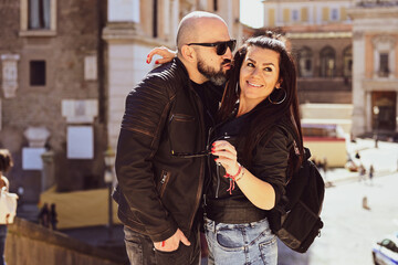  Portrait  of Happy  Tourists  couple   in love traveling at Rome, Italy,    Hugging   at Campidoglio Square.Concept of Italian travel. 