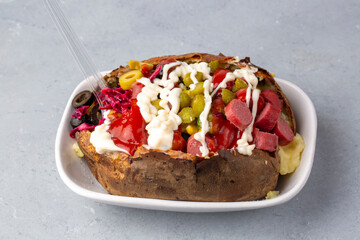 Kumpir, Turkish baked potato with cheese, corn, sausage, ketchup, mayonnaise and olives. This kumpir is traditional turkish food