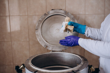 medicine science factory staff worker products sterilize process in autoclave tank in lab.