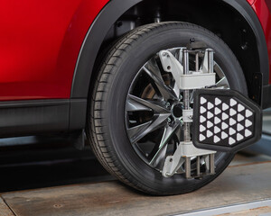 Alignment of car wheels in a car service.