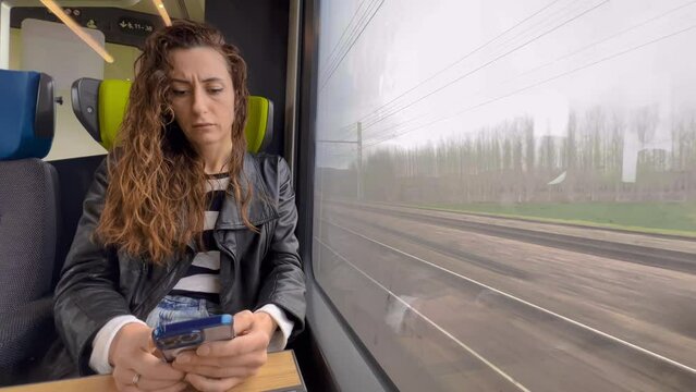 Woman using mobile phone in public speed train. Urban city lifestyle and commuting in French concept