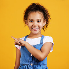 Portrait, smile and girl pointing to space, direction and choice against a studio background. Face,...