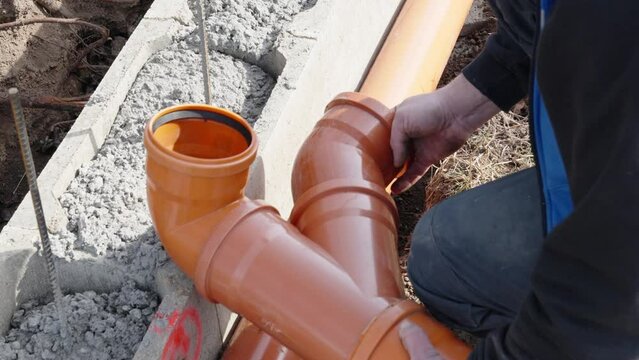 installation of a sewage plastic pipe during the construction of a house