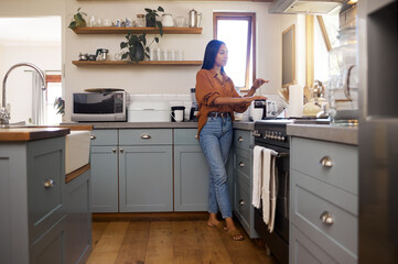 Kitchen, thinking and woman prepare coffee for breakfast latte, cappuccino and hot beverage at home. Relaxation, calm morning and thoughtful girl make espresso, caffeine drink and brewing for peace - Powered by Adobe