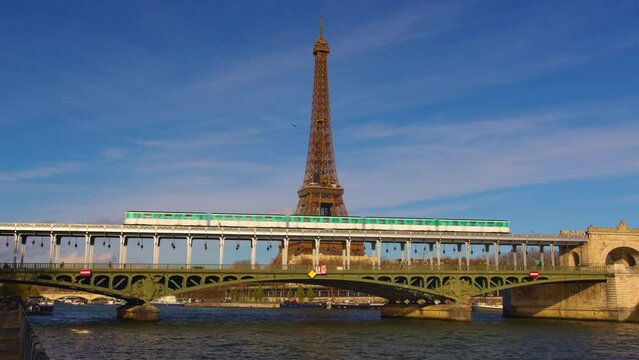 The Paris Metro is one of the popular attractions in Paris. Iron bridge over the river in Paris near the metal tower on which the Paris metro passes. Metro train over Bir-Hakeim bridge