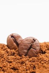 Roasted coffee beans and coffee powder on white background. Closeup