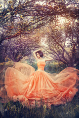 Beautiful young asian fantasy woman in image river fairy dances on flowering garden. Long silk...